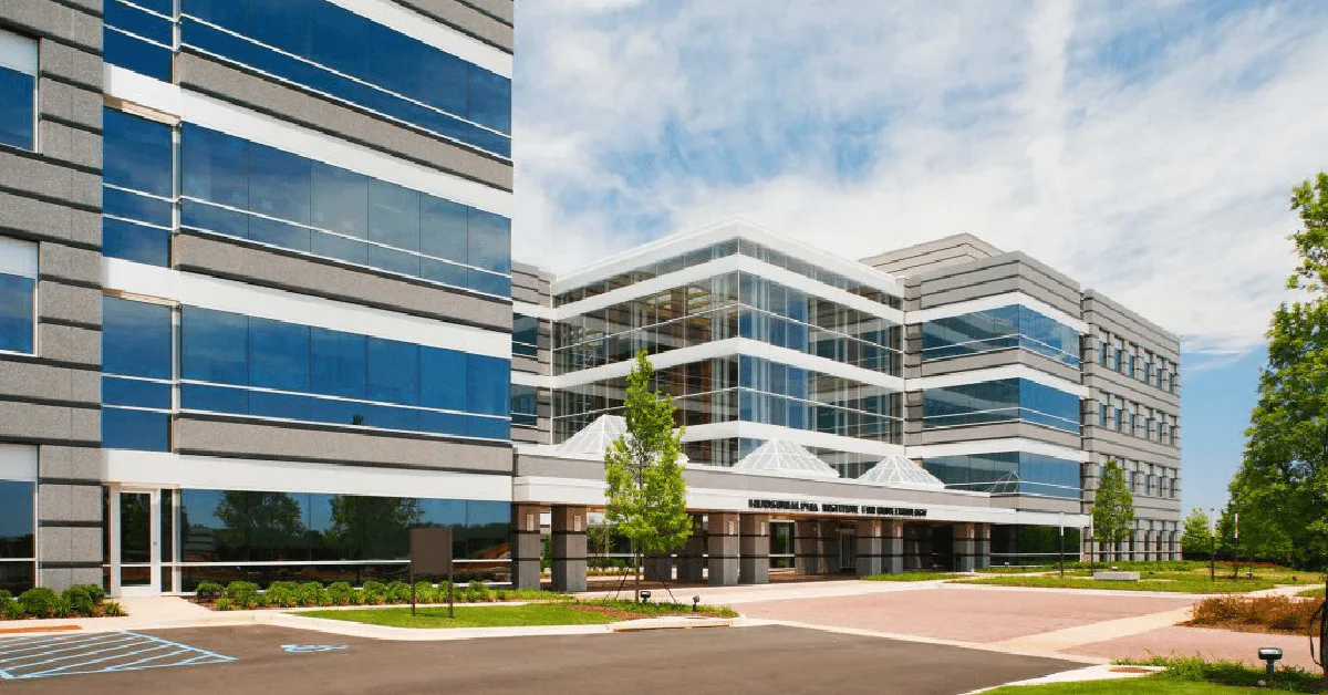 White, beige, and blue glass, 4-5 story office building where iRepertoire is housed on the Hudson Alpha campus in Huntsville, Alabama
